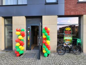 ein Fahrrad, das vor einem Gebäude mit Ballons geparkt ist in der Unterkunft NEW in GDAŃSK! RED ROOM in the HEART of GDAŃSK - BDSM - with a luxury JACUZZI and access to a sauna in Danzig
