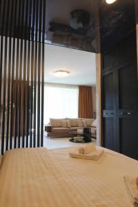 a bedroom with a bed and a couch in a room at Cozy Constellations in Poiana Brasov