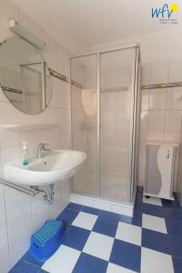 a bathroom with a sink and a shower at Huus 24 in Borkum
