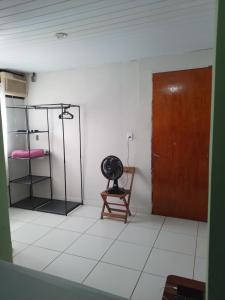 a room with a wooden door and a chair at Lapa Casa Hostel in Rio de Janeiro