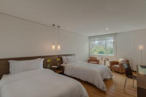 Postel nebo postele na pokoji v ubytování Hotel Poblado Alejandria