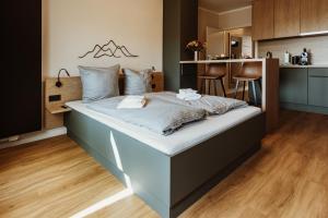 Cette chambre comprend un grand lit et une cuisine. dans l'établissement Harzchalet Emma 3 - mit Sauna - Sankt Andreasberg, à Sankt-Andreasberg