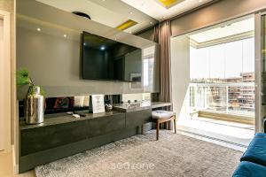 a living room with a sink and a large window at Sophisticated fit with 3 suites Jurere LES403 in Florianópolis