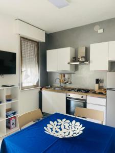 a kitchen with a table with a blue table cloth on it at Casa ORI in Montesilvano