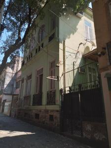 a green and white building on a street at Lapa Casa Hostel in Rio de Janeiro