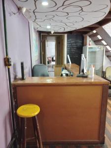 a bar with a yellow stool in a restaurant at Lapa Casa Hostel in Rio de Janeiro