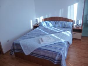 a bedroom with a bed with a blue and white blanket at Pensiunea Simona in Perişor +60 photos
