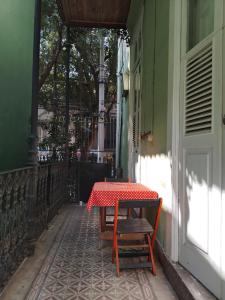 a table and a bench on the side of a building at Lapa Casa Hostel in Rio de Janeiro
