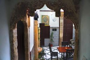 an archway in a house with a table and chairs at Riad Palais D'Or in Rabat