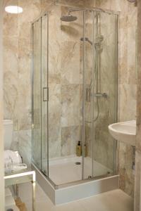 a shower with a glass door in a bathroom at Old Garden  +49 photos