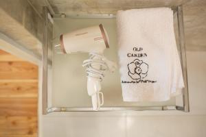 a towel rack with a hair dryer and a towel at Old Garden in Sycewo
