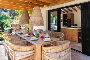 a dining room with a table and chairs at Ca Jardi, Luxury Ibiza-Style villa with private pool, Javea in Jávea