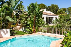 a swimming pool in front of a house at Ca Jardi, Luxury Ibiza-Style villa with private pool, Javea in Jávea