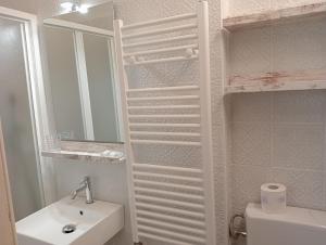 a bathroom with a toilet and a sink and a mirror at Buonanotte Rooms in Lucca