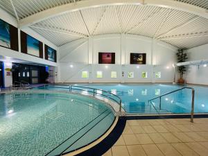 a large swimming pool in a large building at HomeDecor Cottages - The Sands Cottage in Seahouses +33 photos