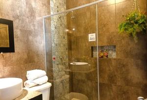 a bathroom with a shower with a toilet and a sink at Alberca-Privacidad-Confort in Mérida