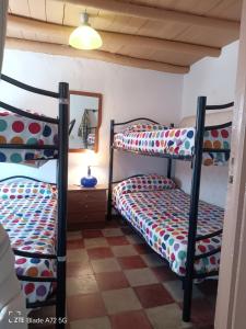 two bunk beds in a room with a mirror at La casita en la Alcornocosa -Sevilla in Seville