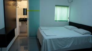 Postel nebo postele na pokoji v ubytování Hotel Tres Bandeiras
