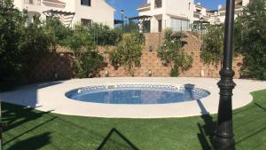a small pool in a yard with a light pole at El Olmo in Seville