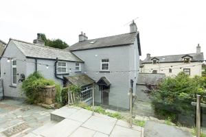 a house with a fence in front of it at OLD BANK HOUSE - Perfect Getaway for Friends & Families in Holker
