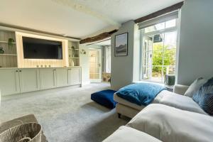 a bedroom with two beds and a flat screen tv at OLD BANK HOUSE - Perfect Getaway for Friends & Families in Holker