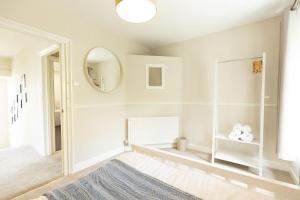a white room with a mirror and a blue rug at OLD BANK HOUSE - Perfect Getaway for Friends & Families in Holker +33 photos