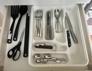 a tray with silver utensils sitting on a counter at Huoneisto kaupungissa Joensuu in Joensuu