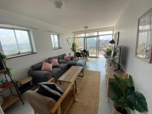 a living room with a couch and a table at Chasing The Sun in Durban