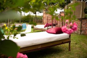 a bed with pillows on it in a yard at Old Garden in Sompolno