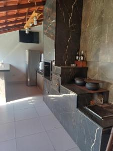a kitchen with a counter with pots and pans at Antônio Teixeira in Barão de Geraldo