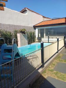 a swimming pool with a slide in a fence at Antônio Teixeira in Barão de Geraldo