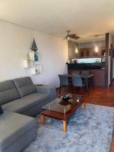 a living room with a couch and a table at Discovery Apartment with patio Discovery 2 in Machico