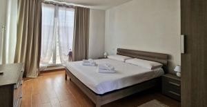 a hotel room with a bed and a large window at Casa Vacanze Rebecca in Pula