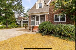 a brick house with a driveway in front of it at Historic Home, Modern Amenities- 15 Minutes to Downtown Chattanooga- Perfect for Families in Signal Mountain