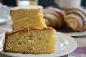 a piece of cake on a white plate with pastries at Locanda Villa Moderna in Genoa