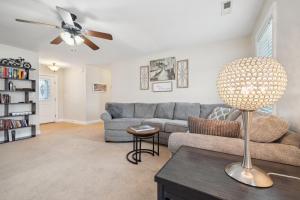 a living room with a couch and a ceiling fan at Charming Family Retreat with Spacious Yard home in Elizabeth City