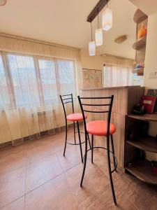 two black and orange chairs in a kitchen at Vernisaj apt at Republic Square & Ruben tours in Yerevan