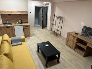 a living room with a yellow couch and a table at NIKA The architect DIAMOND OF GEVGELIA in Gevgelija