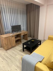 a living room with a tv and a couch and a table at NIKA The architect DIAMOND OF GEVGELIA in Gevgelija