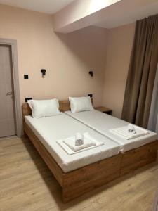 a bedroom with a bed with two towels on it at NIKA The architect DIAMOND OF GEVGELIA in Gevgelija