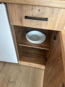 a plate in a wooden cabinet with a plate in it at NIKA The architect DIAMOND OF GEVGELIA in Gevgelija