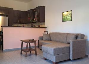 a living room with a couch and a table at Sapfous apartment in Igoumenitsa