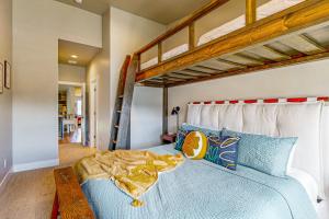 a bedroom with a blue bed with two bunk beds at Lakeside Luxury in Heber City