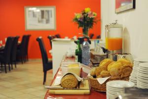 a table with bread and other food on it at Bellevue Hotel in Düsseldorf
