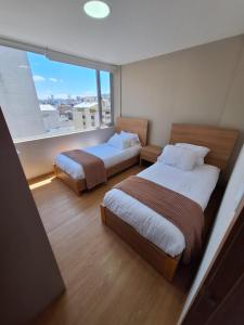 Postel nebo postele na pokoji v ubytování Suite en Iñaquito - Edificio Bernini