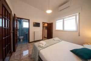 Un dormitorio con una cama grande y un baño. en Villa Eucalipti sul mare, en Bari