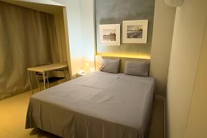 a bedroom with a white bed in a room at Suítes Aconchegantes na Barra da Tijuca, Link Stay in Rio de Janeiro
