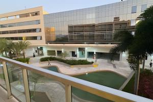 an external view of a building with a courtyard at Flats Aconchegantes na Barra da Tijuca, Link Stay in Rio de Janeiro +30 photos