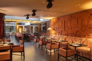 a restaurant with tables and chairs in a room at EVOLUTION Valbom in Lisbon +46 photos