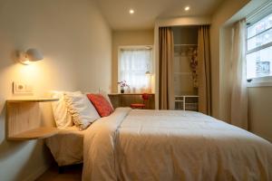 a bedroom with a large bed and a window at Miña Nai Apartment in Ferrol